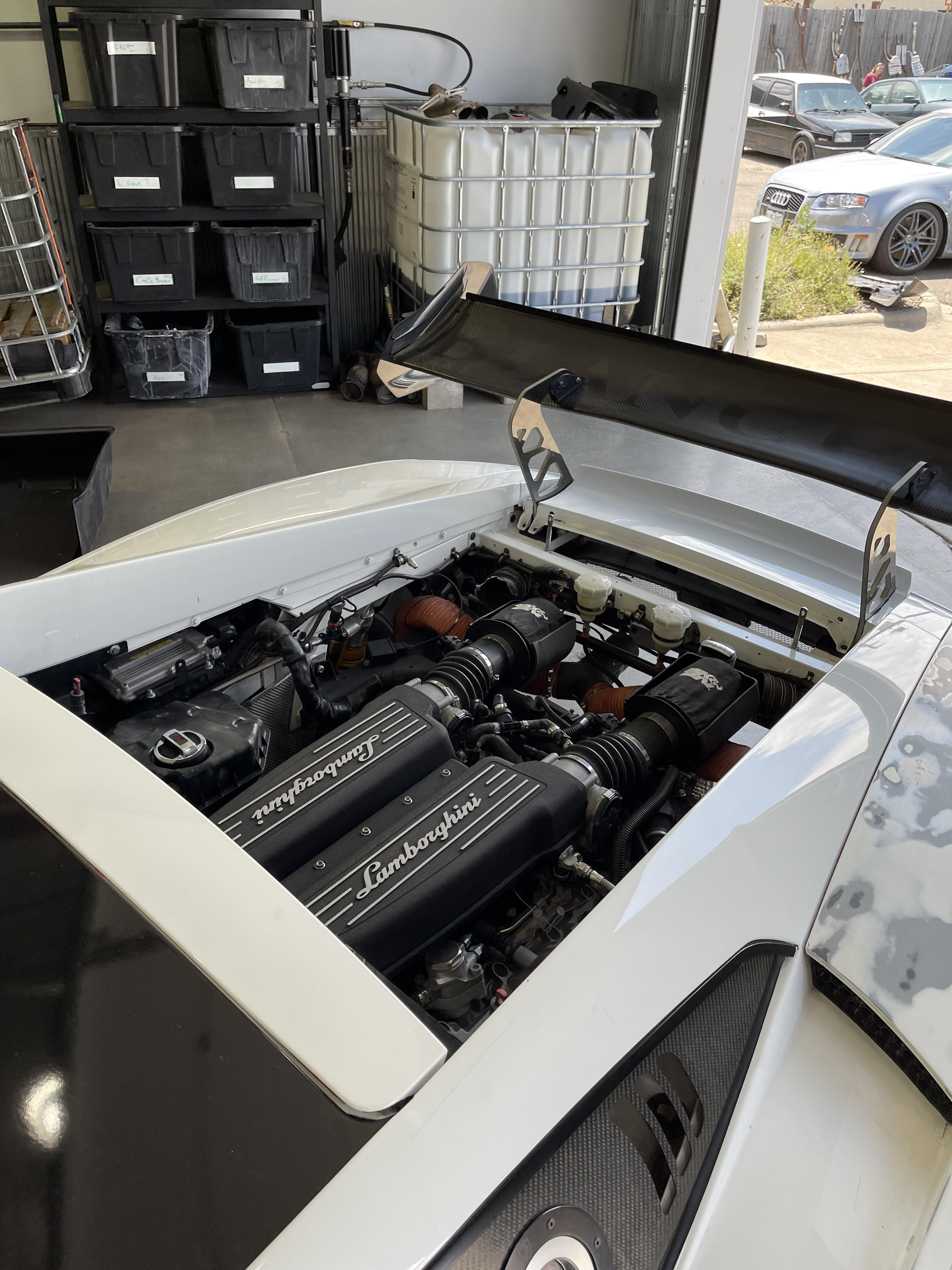 Lamborghini in the garage with its engine exposed